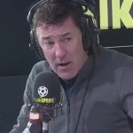 Former Wales striker Dean Saunders wearing headphones and speaking into a talkSPORT microphone in the radio studio