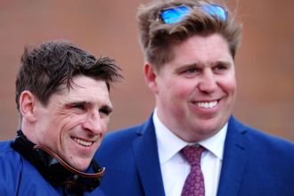 Jockey Harry Skelton, left, and his brother, trainer Dan Skelton, smiling at a racecourse