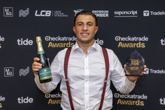 Jacob Lovell of Lovell Roofing, Gowerton, holding his Roofer of the Year trophy and a bottle of champagne at the Checkatrade Regional Awards for Midlands and Wales