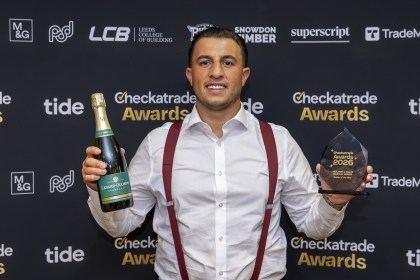 Jacob Lovell of Lovell Roofing, Gowerton, holding his Roofer of the Year trophy and a bottle of champagne at the Checkatrade Regional Awards for Midlands and Wales