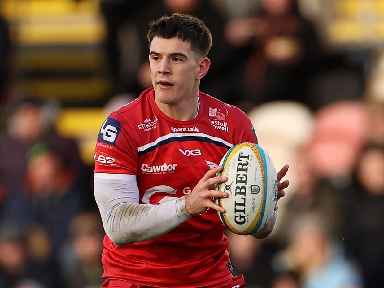 Scarlets centre Joe Hawkins with the ball in hand during a URC match