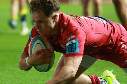 Scarlets wing Macs Page diving to score a try in a URC match