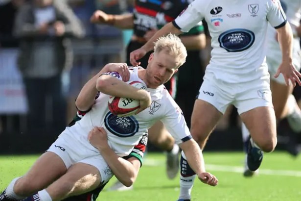 Swansea RFC full-back Mat Protheroe carries the ball into a tackle against Ebbw Vale