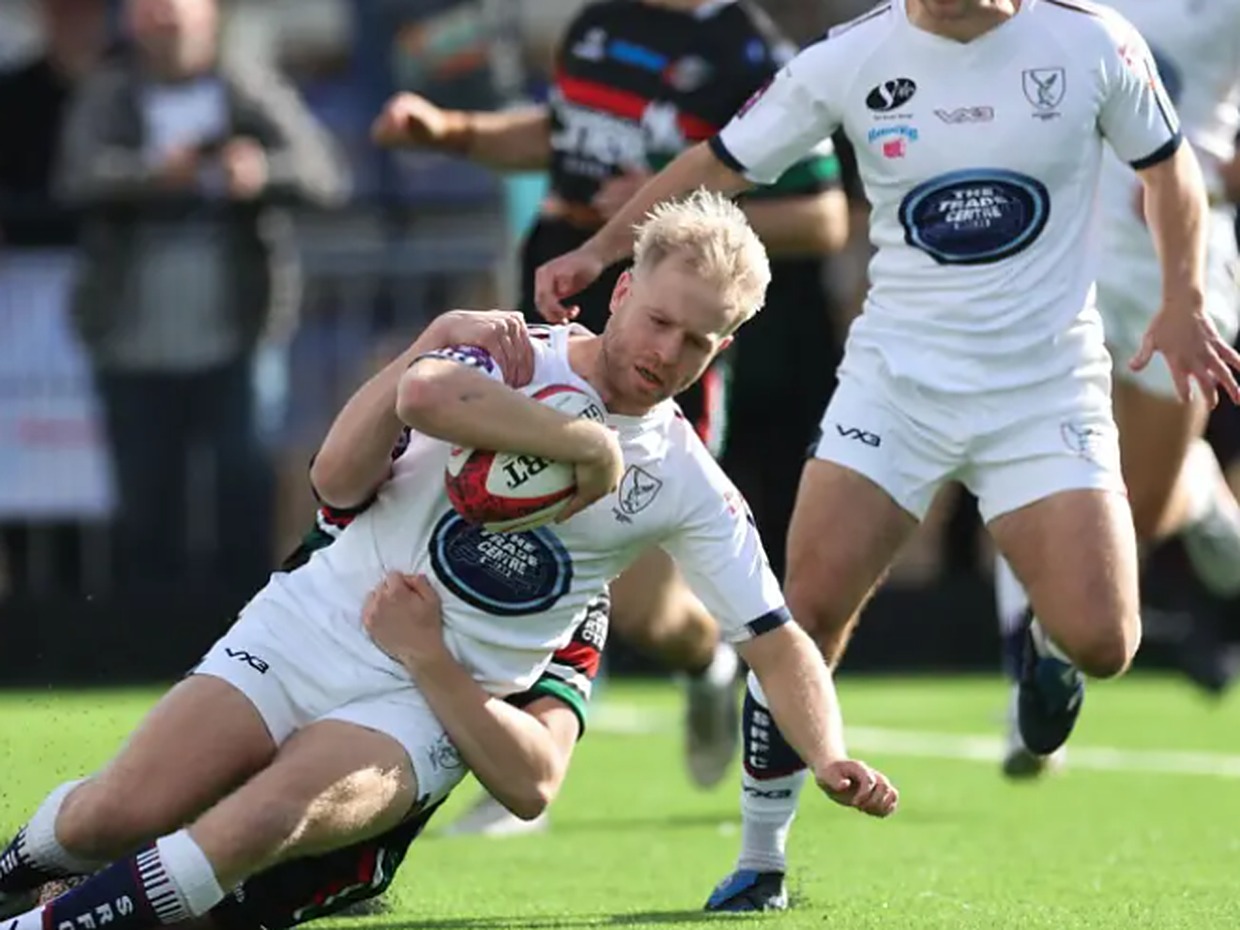 Swansea RFC full-back Mat Protheroe carries the ball into a tackle against Ebbw Vale