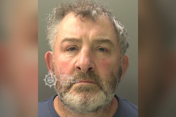 South Wales Police custody photograph of Michael Davies, a grey-haired man with a beard