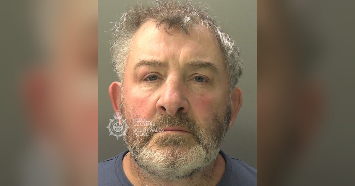 South Wales Police custody photograph of Michael Davies, a grey-haired man with a beard