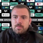 Ospreys number eight Morgan Morris at a press conference in front of a sponsor board