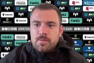 Ospreys number eight Morgan Morris at a press conference in front of a sponsor board