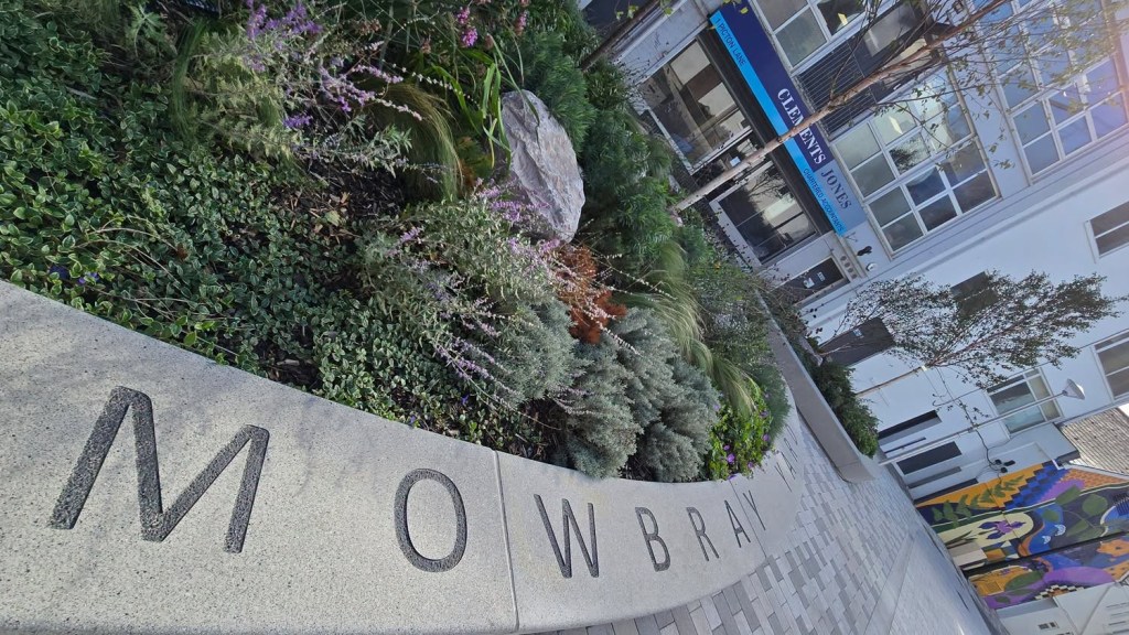 The words Mowbray Yard set into a planter wall in Swansea city centre
