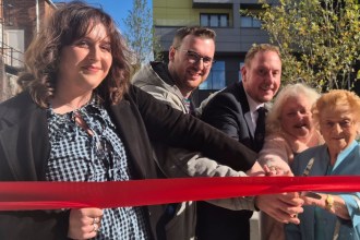 Guests cut a red ribbon to open Mowbray Yard in Swansea city centre