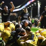 Ospreys players celebrate as a maul goes over the Dragons' line at Rodney Parade