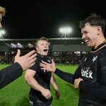 Ospreys players Iestyn Hopkins and Tom Rogers smile and celebrate on the pitch at Rodney Parade after the win over the Dragons