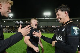 Ospreys players Iestyn Hopkins and Tom Rogers smile and celebrate on the pitch at Rodney Parade after the win over the Dragons