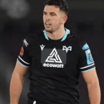 Ospreys centre Owen Watkin in the club's black home kit during a match under floodlights