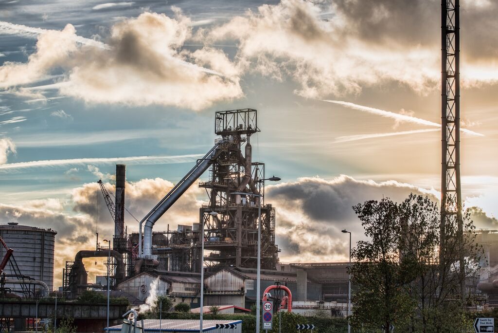A blast furnace at the Port Talbot steelworks against a dusk sky