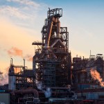 The blast furnaces and stoves at Tata's Port Talbot steelworks at sunset, with steam rising from the pipework