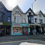 The turquoise-fronted former Rainbow childrenswear boutique at 29 Uplands Crescent, next to The Bookshop cocktail bar, in a terrace of gabled Victorian shops