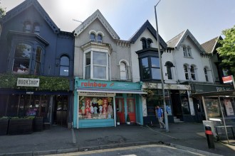 The turquoise-fronted former Rainbow childrenswear boutique at 29 Uplands Crescent, next to The Bookshop cocktail bar, in a terrace of gabled Victorian shops