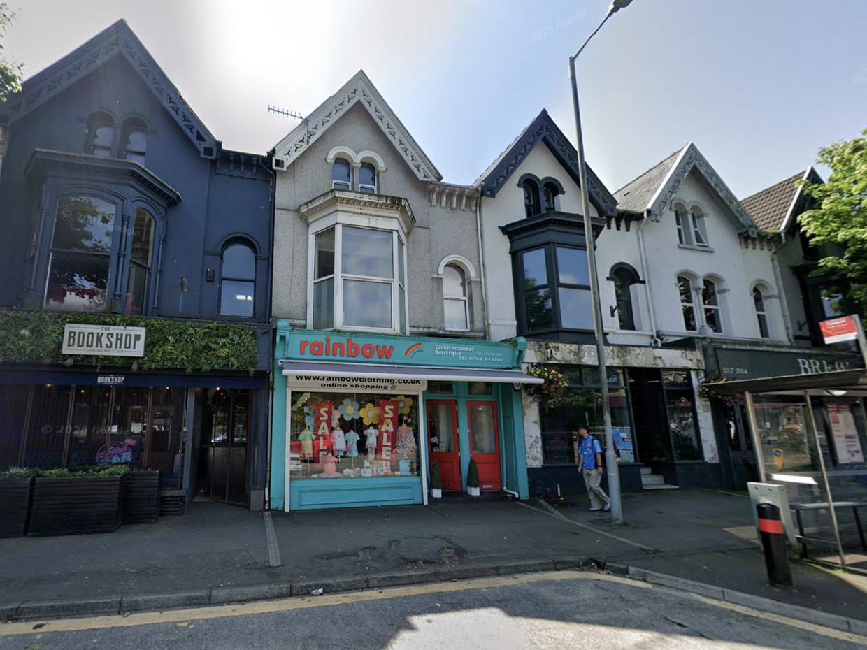 The turquoise-fronted former Rainbow childrenswear boutique at 29 Uplands Crescent, next to The Bookshop cocktail bar, in a terrace of gabled Victorian shops