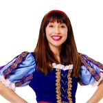 Rebecca Keatley smiling with her hands on her hips in a Snow White costume with a red headband, blue velvet bodice and puffed blue sleeves