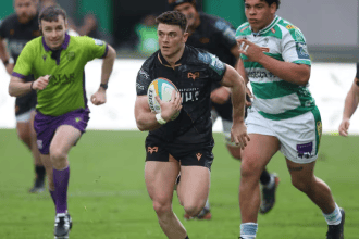 Ospreys scrum-half Reuben Morgan-Williams runs with the ball in open field, chased by a Benetton player.