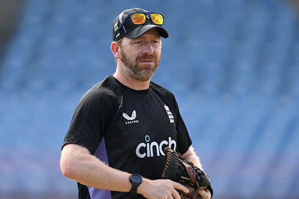 Richard Dawson in England training kit and cap, holding a catching mitt, with empty blue stadium seats behind him