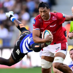 Scarlets lock Sam Lousi, in red, carries the ball through a tackle from a Stormers player in blue and white hoops.
