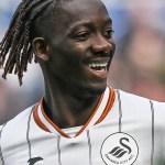 Swansea City winger Moussa Yeo smiling in the white Swans home kit