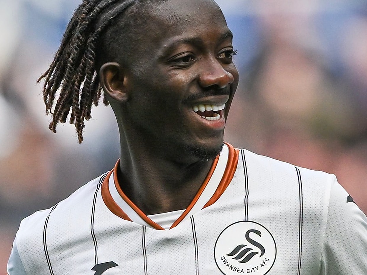 Swansea City winger Moussa Yeo smiling in the white Swans home kit