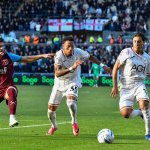 Swansea City's Ronald, number 35, chases the ball with a teammate and a West Ham player at the Swansea.com Stadium