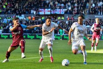 Swansea City's Ronald, number 35, chases the ball with a teammate and a West Ham player at the Swansea.com Stadium