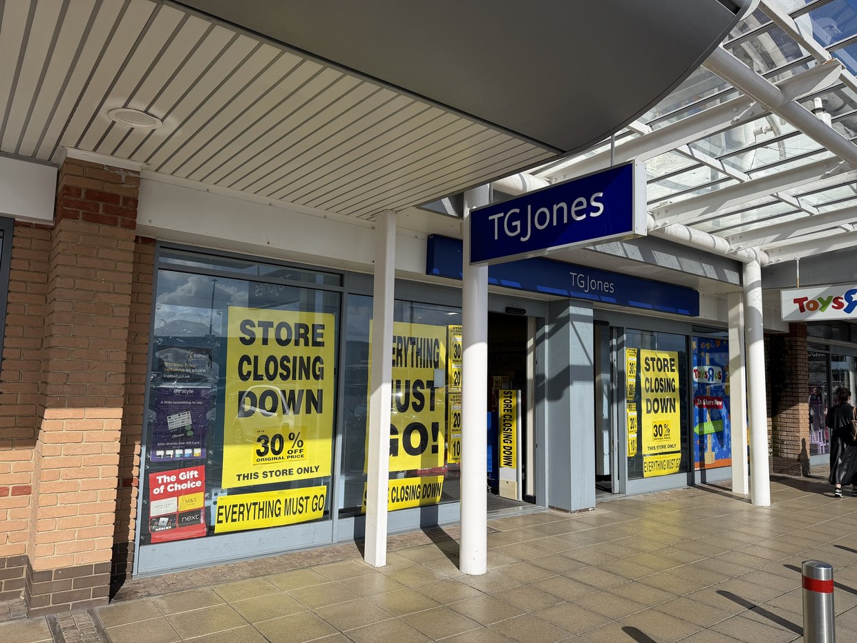 Yellow store closing down posters in the windows of the TGJones shop at Parc Trostre retail park in Llanelli