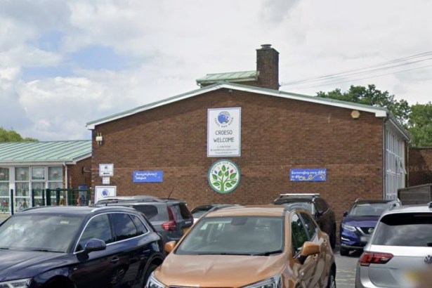 The front of Ysgol Bro Banw primary school in Ammanford, a red-brick building with a Croeso Welcome sign
