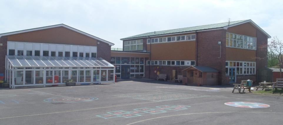 Ysgol Griffith Jones primary school in St Clears, a brick building with a glass walkway and playground markings in the yard