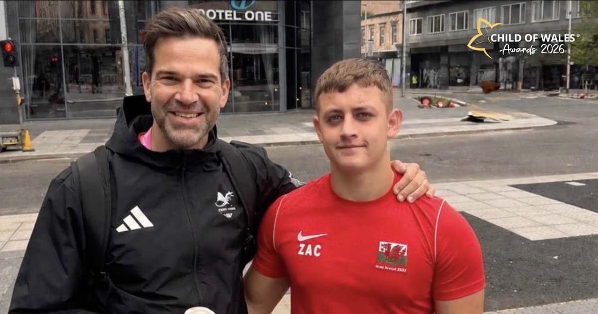 Gethin Jones with his arm around Zac Thomas, who wears a red Wales top with ZAC on the chest, in Swansea city centre